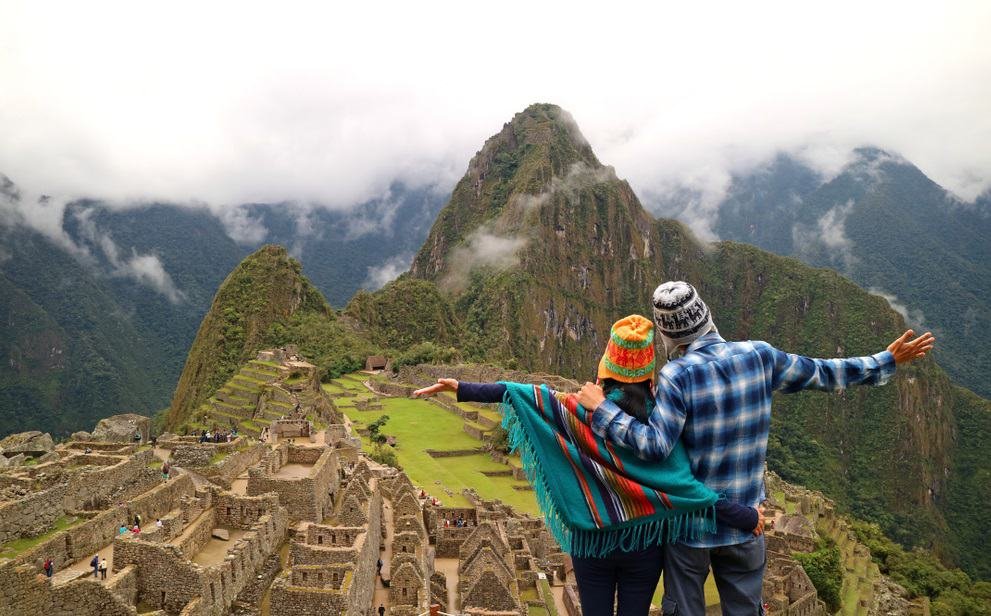 Couple admiring the spectacular view of Machu Picchu