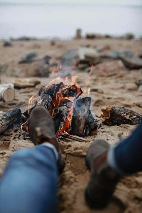 Feet near a campfire